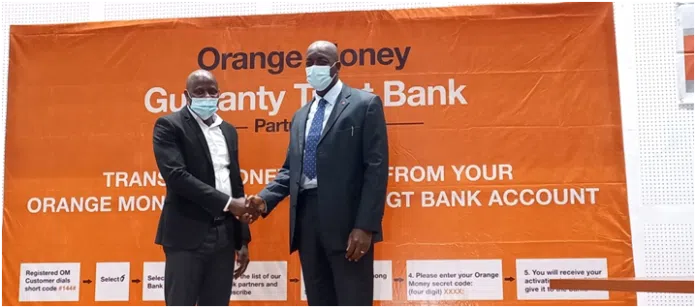 Orangemoney CEO, David Mansaray with GTBank’s Managing Director, Ade Adebiyi…celebrating the partnership