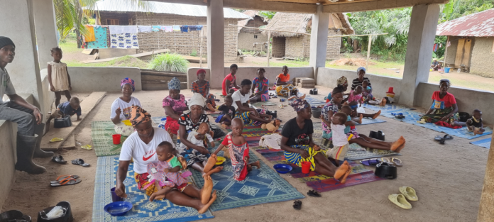 Caregivers and their children at Taninahun Community in Makpele Chiefdom, Pujehun District