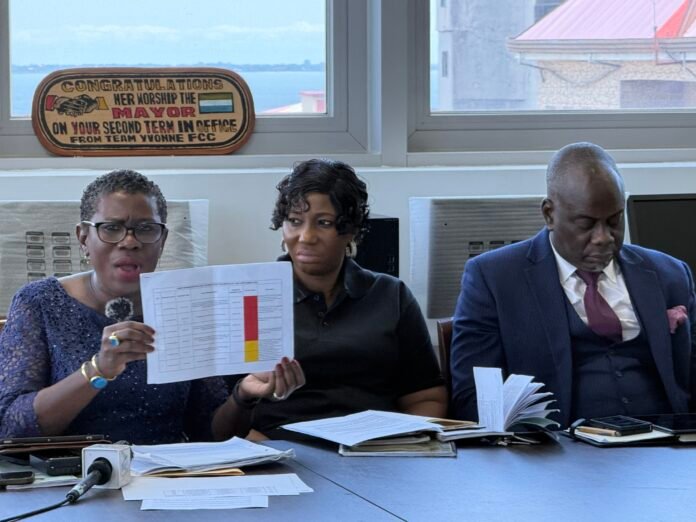 Her Worship Yvonne Aki-Sawyerr showing document to journalists during FCC's press conference