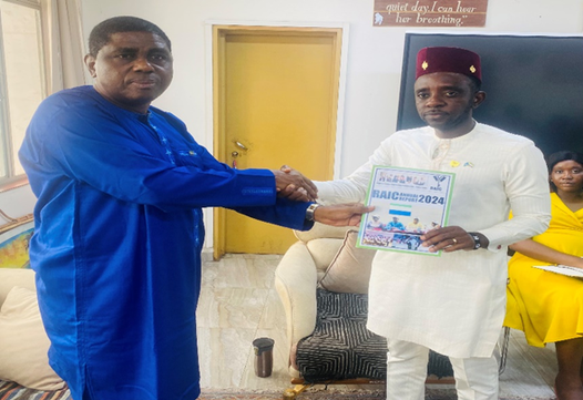 Chairman of RAIC, Dr. Ibrahim Seaga Shaw presenting the Commission’s 2024 Annual Report the Minister of Information and Civic Education, Chernor A. Bah