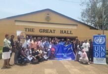 UNDP Unveils Circular Innovation Club at MMTU to Promote Youth-Led Solutions A large group of people posing for a group photo in front of a building labeled 'THE GREAT HALL', with a UNDP banner on the right and a blue 'Youth for Circularity 2030' banner in the center.