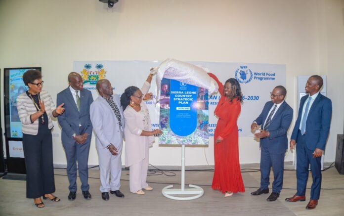Officials unveil a poster titled Sierra Leone Country Strategic Plan 2026–2030 at a World Food Programme event.