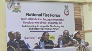 Panel of speakers seated at a conference table in front of a large banner reading 'National Fire Force' and related text.
