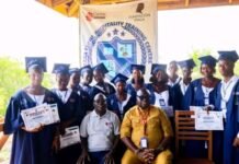 CASA Leone Hospitality Training Centre Holds Maiden Graduation Ceremony Group of graduates in blue gowns with certificates posing for a photo at a hospitality training center graduation event.