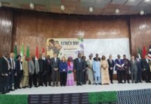 Africa Day 2026: African Diplomats, Government Renew Calls for Unity and Sustainable Development Dignitaries in formal attire pose on stage at Africa Day 2026, flags lined up behind them.