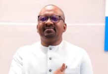 Vice President Declares 2026 ‘Year of Execution’, Positions Workers as Architects of Development Man in a light-colored traditional suit places his right hand over his heart while standing indoors.