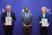Accompanied by Deputy Ambassador Asmaa James… Ambassador Philip Bob Jusu Presents Credentials to EU Leadership in Brussels Three adults in suits pose against a blue backdrop with European Commission logos; the two on the ends hold framed certificates.