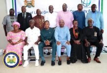 Vice President Calls for Results-Oriented Decentralization Reforms Group of officials posing for a formal group photo at a government event, with a banner and seal in the background.