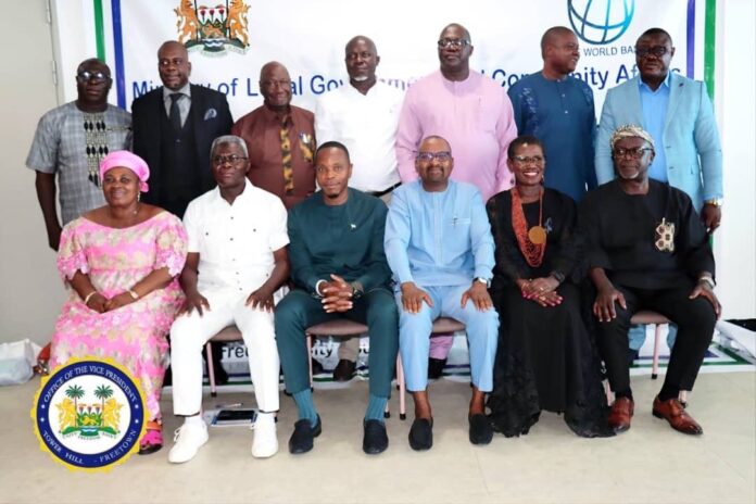 Group of mostly African officials posing for a formal group photo at a governance event, with a World Bank banner and official seal in the background.