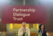 Austria Highlights Communication Strategy, UNSC Bid During Media Fellowship Briefing Panel discussion at a Partnership Dialogue Trust event, with two speakers seated at a long table and bottled water in front of them.