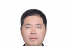 Ambassador Zhao Yong Had a Written Interview with Sierra Leonean Media on the Taiwan Question Professional headshot of a man in a dark suit, light blue shirt, and purple tie, looking at the camera against a white background.