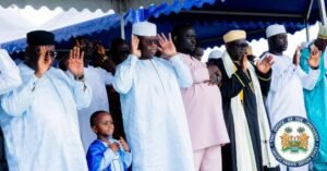 | The Calabash Newspaper Group of officials in traditional attire raise their hands in a pledge/oath under a blue canopy, with a young boy in blue at the front left.