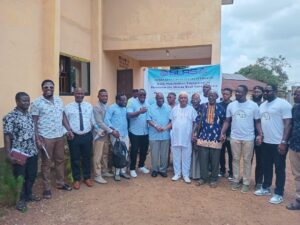 Group of participants posing outside a building with a Sierra Leone Road Safety Authority banner in the background.