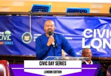 During London Civic Day Event… Vice President Highlights Government Reforms, Investment Opportunities and National Development Man in a blue shirt speaks into a microphone at a podium during a Civic Day Series London edition event, with a blue banner in the background.