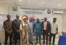 SLRDRA Holds Stakeholder Consultative Meeting on Development of National Railway Master Plan Seven people stand in a conference room in front of a banner for a stakeholder consultative meeting on a national railway masterplan and feasibility studies.