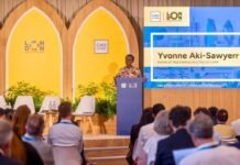 Freetown Mayor Engages World Leaders to Advance Urban Climate Solutions at London Summit Speaker at a podium during London Climate Action Week, with C40 Cities branding and a large screen showing Yvonne Aki-Sawyerr.