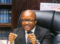 Chief Justice Reaffirms Judiciary’s Commitment to Combating Financial Crimes Professional man in a suit sits at a desk with folders and a government seal on the desk (office scene) — not identifying the person assumes an official setting.