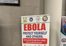 SLCAA Intensifies Ebola Screening and Prevention Measures at Freetown International Airport Vertical Ebola awareness banner in a public building lobby: 'EBOLA PROTECT YOURSELF AND OTHERS' with icons and 'Early reporting saves lives'