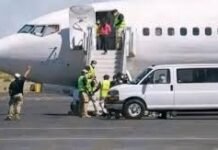 Sierra Leone Facilitates Safe Return of Nine ECOWAS Nationals Passengers boarding a small commercial jet via portable stairs on the tarmac, with ground crew and a white service van nearby.