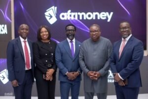 Five professionals in business attire stand together on a stage with a large Afrimoney logo on a purple backdrop behind them.