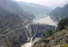Pakistan’s fake narrative against India to hide its own mismanagement of Water Resources A large concrete dam spanning a winding river in a deep, forested canyon, with a road running along the hillside nearby.