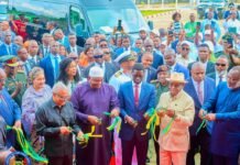 President Bio Commissions International Conference Centre, ECOWAS Logistics Depot to Advance Regional Development Dignitaries and officials cut yellow-and-green ribbons at an outdoor ceremony, with a crowd and a blue van in the background.