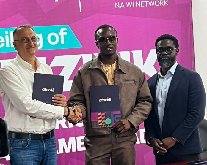 Three men in a ceremony shake hands; two hold navy folders with the africell logo against a bright magenta backdrop.