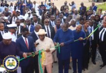 Vice President Juldeh Jalloh Congratulates President Bio on Successful ECOWAS Summit Group of dignitaries cutting a green ribbon at a formal ceremony as a large crowd looks on in the background.