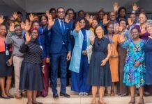 UNFPA Sierra Leone and Government Partners Mobilize to Operationalize AU Accountability Framework on Harmful Practices Group of diverse colleagues smiling and waving from a doorway, celebrating together.
