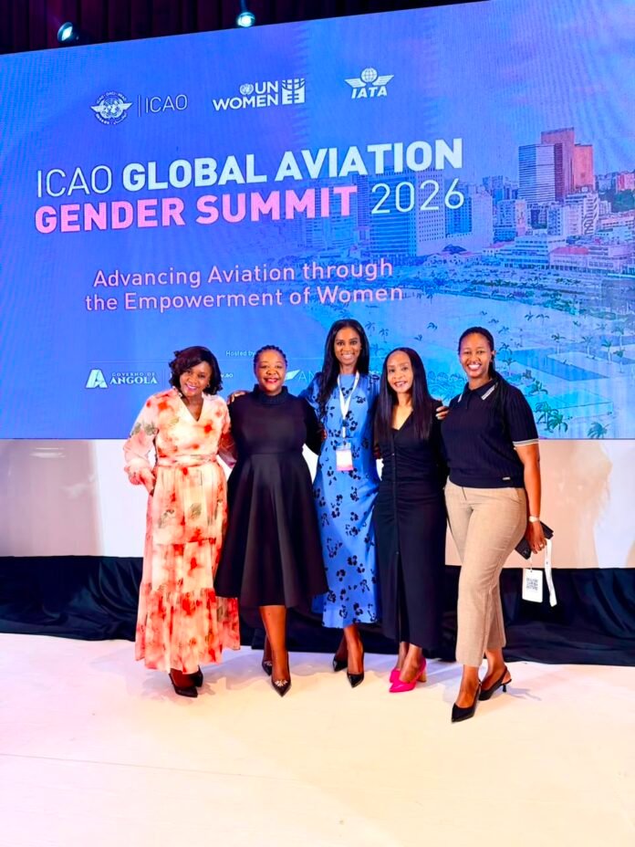 Five women posing on stage in front of a blue banner that reads 'ICAO Global Aviation Gender Summit 2026' with the subtitle 'Advancing Aviation through the Empowerment of Women'