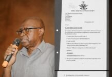 Investigation Reveals Airport Fee Suspension May Trigger Costly Contract Dispute and Renew Focus on Missing K5 Collections Older man wearing glasses and a grey shirt speaks into a handheld microphone beside a large printed document in a binder.