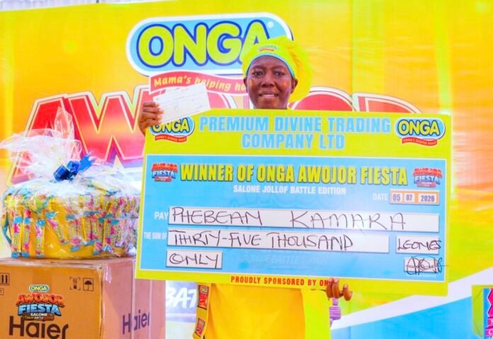 Smiling woman in yellow holding an oversized blue winner's cheque at an ONGA event.