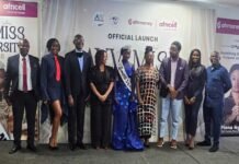 AYV and NUSS Launch Miss University 2026 Group of professionally dressed people posing on a stage at an official launch, with banners and sponsor logos in the background.