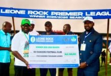 As Bo Rangers Crowned Champions… Leone Rock Metal Group Marks Historic Premier League Finale with Record US$180,000 Sponsorship Group of men on a football field holding an oversized cheque for BO Rangers FC, winner 2025–2026 Leone Rock Premier League, with a league banner overhead.
