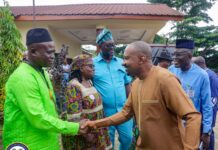 COMMENTARY – Five Key Lessons from Vice President Dr. Mohamed Juldeh Jalloh’s Nationwide Local Government Tour Dignitaries greet each other with a handshake outside a building, wearing bright traditional outfits and head wraps.