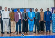Orange Sierra Leone, Orange Money Join National Fight Against Mobile and Digital Fraud Group of professionals posing for a formal portrait on a stage at the Ministry of Communication, Technology and Innovation event.