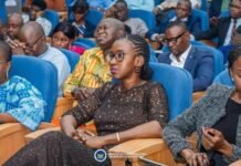 Orange Strengthens Digital Fraud Fight with *505# Scam Alert Tool, Backs National Roadmap Group of professionals seated in blue theater seats at a conference, attentively watching a presentation.