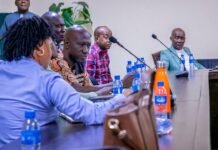 ECSL Finalizes University Curriculum on Political and Electoral Education A panel of six people seated at a conference table with microphones, water bottles, and a bright orange flask in the foreground, discussing.