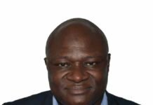Celebrating Excellence: Braima Koroma and Co-Authors Win 2026 Best Paper Award Portrait of a smiling Black man in a navy blazer and light blue shirt against a white background
