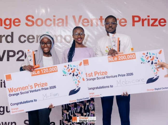 Three prize winners pose with oversized checks for the Orange Social Venture Prize at a ceremony, showing large amounts on the boards.