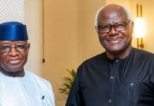 Bio Calls for Reconciliation as Criminal Proceedings Against Former President Koroma Discontinued Two older men in traditional attire pose and smile indoors.