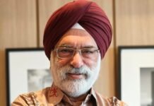 India’s Space Sector: A Launchpad for Global Partnerships Portrait of a smiling Sikh man with a maroon turban and glasses, arms crossed indoors.