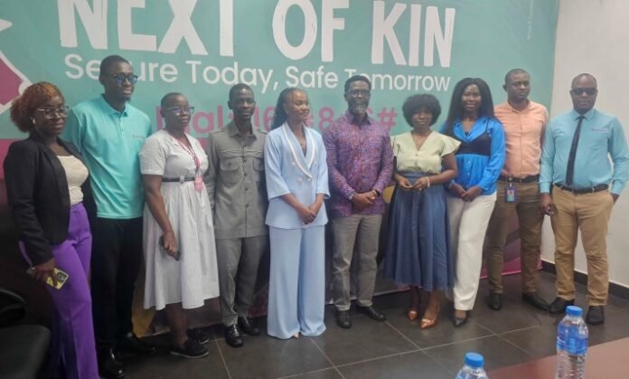 Eleven diverse professionals posing indoors in front of a teal banner that says 'NEXT OF KIN' and 'Secure Today, Safe Tomorrow'.