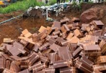 Joint Security Destroys US$300 Million Drug Consignment in Major Anti-Narcotics Operation A large pile of broken chocolate bars spilling from a muddy trench at a construction site.