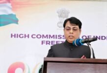 Indian High Commission Commemorates 80th Independence Day with Focus on Democracy Speaker at a podium delivering a speech at an event, with a banner reading 'HIGH COMMISSION OF INDIA' in the background.