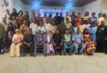 ONS Engages Stakeholders Across Five Regions to Identify Threats Ahead of 2028 Elections Large mixed-group in a hall posing for a group photo in front of a 'Consultative Workshop' banner, wearing colorful traditional and modern clothing.