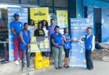 AfriGas, MiKashBoks Launch ‘Save to Buy’ Initiative to Make Clean Cooking More Affordable Group of smiling people posing with AfriGas banners and yellow gas cylinders outside a storefront?