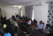 MTHE Bids Farewell to 26 Sierra Leonean Scholarship Awardees Bound for Hungary Group of professionals seated around a long conference table with laptops in a meeting room.