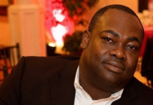 Karefa Kargbo Named Finance Minister in President Bio’s Latest Government Appointments Portrait of a man in a black suit and white shirt at a formal event, looking at the camera.