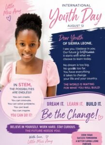 Smiling young girl in a pink dress beside a poster for International Youth Day with STEM and empowerment messages.
